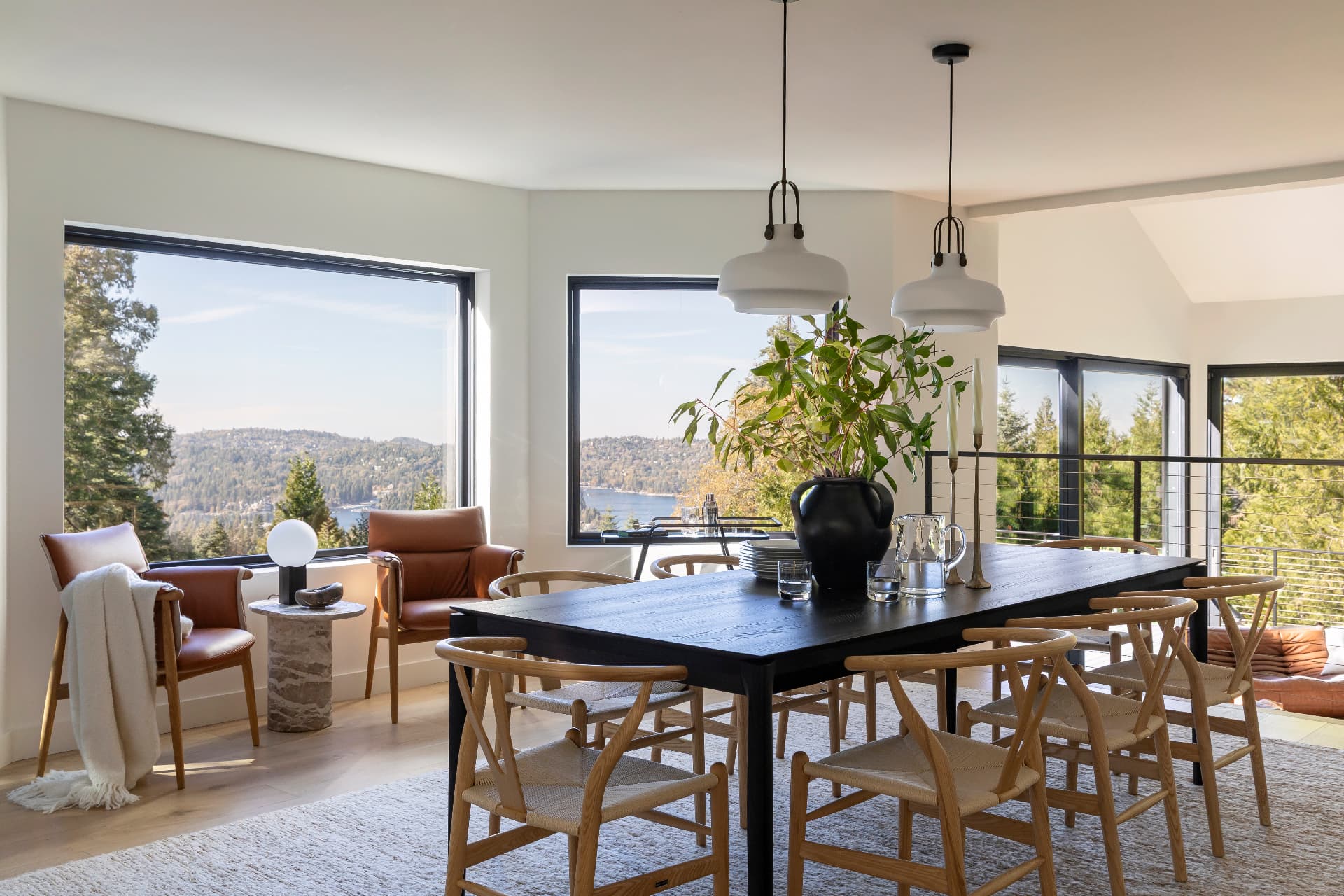 Dining table beside lake-facing windows